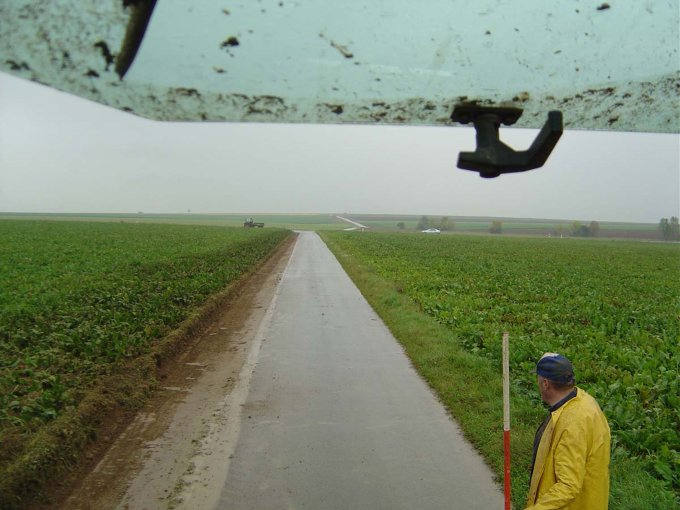 Blick vom Traktor auf einen Flurweg mit gereinigtem Bankett